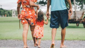 man and woman holding their daughter