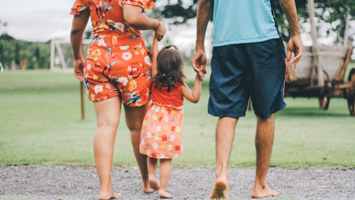 man and woman holding their daughter